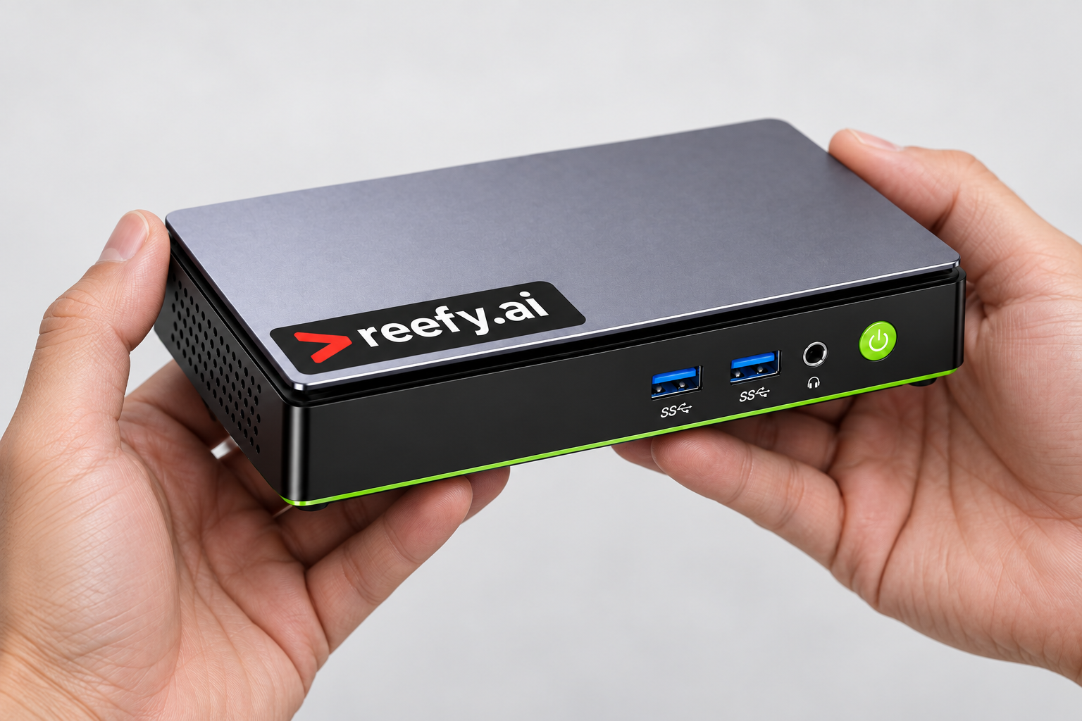 Illustration of the compact Reefy device held in two hands for scale