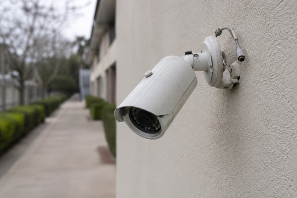 Illustrative scene of a security camera with a damaged wall mount and disconnected cable