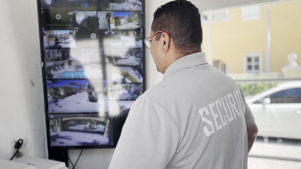Security operator viewing a mosaic of community camera feeds