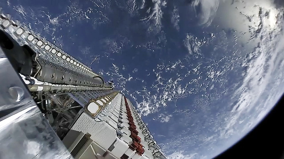 Sixty Starlink satellites stacked atop a Falcon 9 rocket before launch